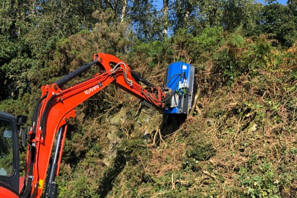 flail mower destroying bushes on kubota excavator