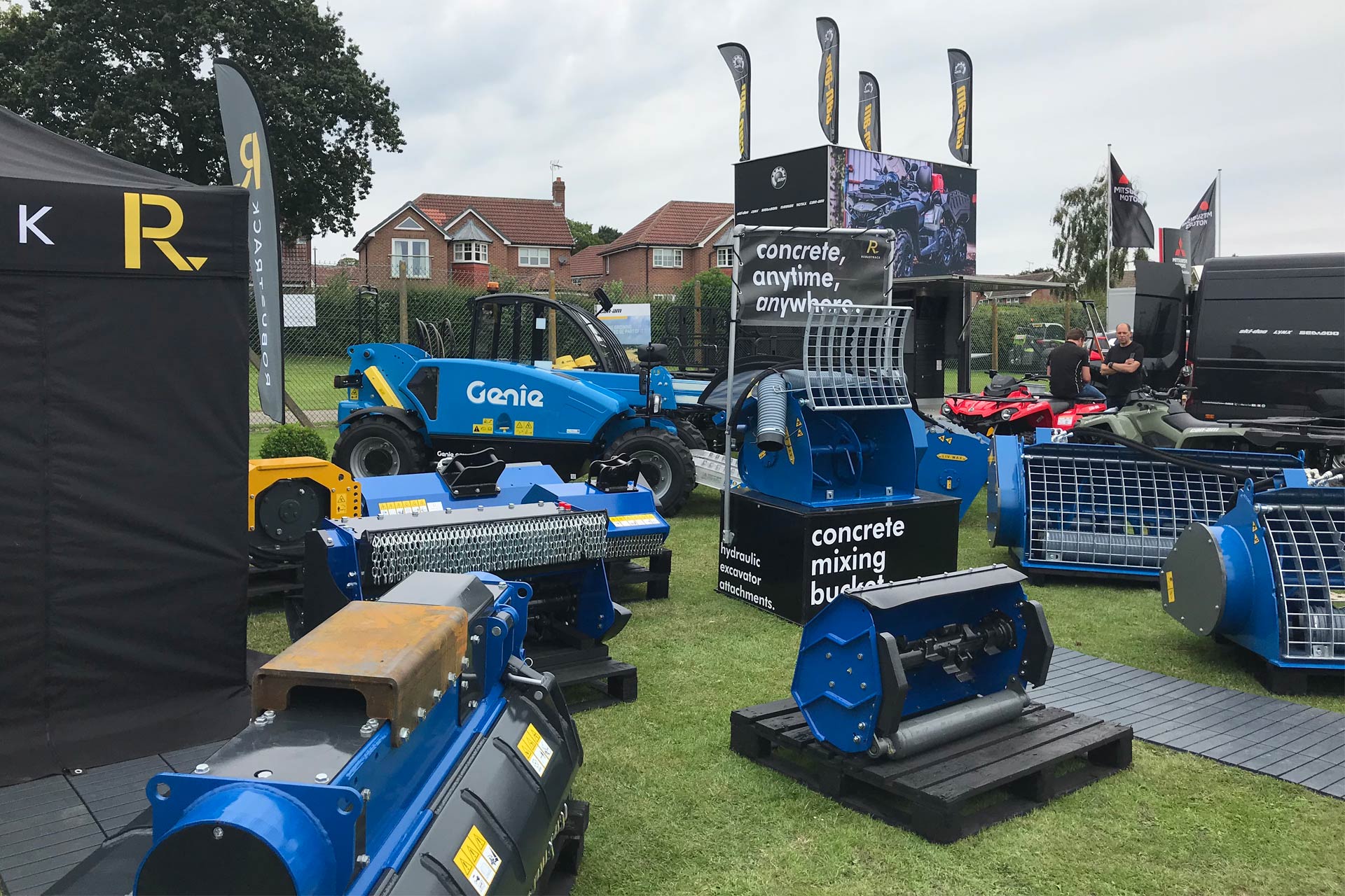 Robustrack show stand with blue excavator attachments