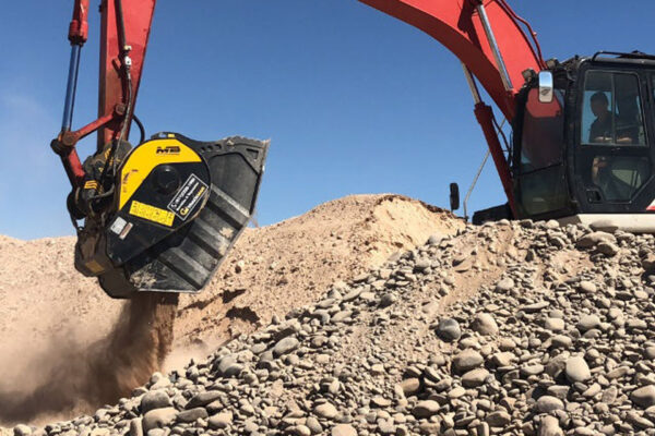 MB Crusher bucket on red excavator crushing rubble