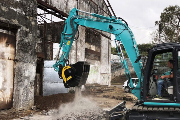 MB C50 crusher bucket on Kobelco working on a demolition site
