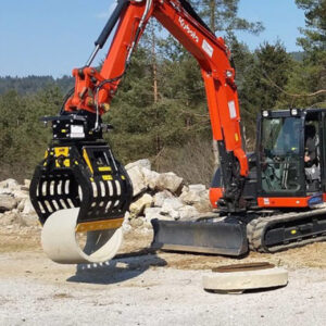 MB Crusher demolition grab attachment lifting a piece of concrete pipe