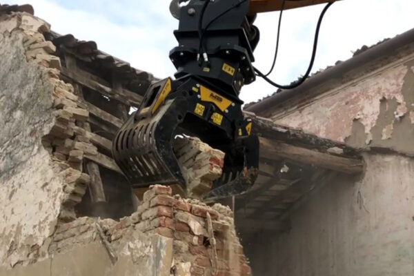 MB Crusher G900 selector grab picking up bricks from a wall being demolished
